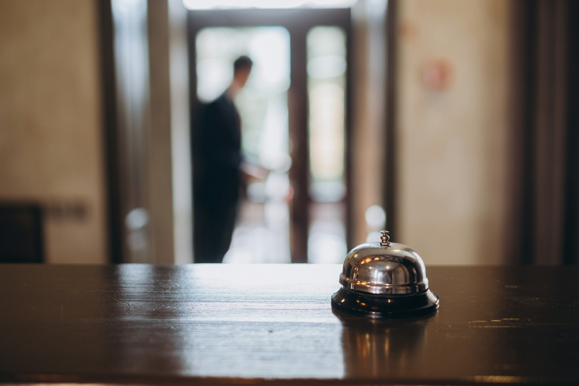 Arrival at the hotel. Reception desk with a bell in the hotel lobby.